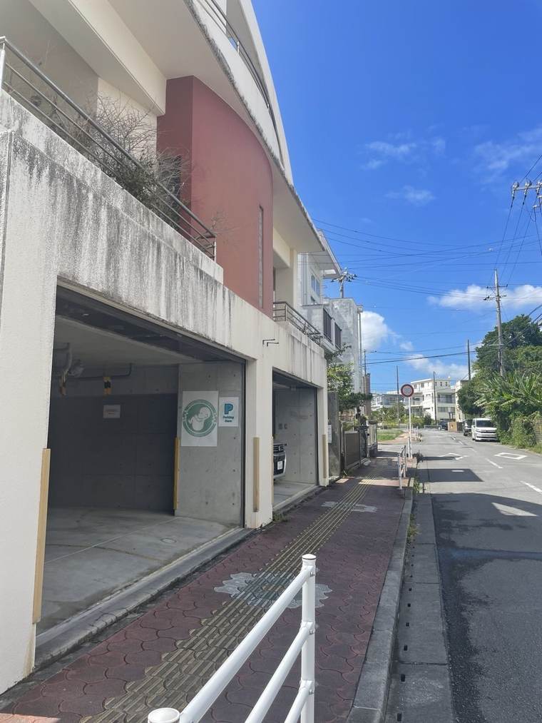Side view of the building showing the ground-floor garages